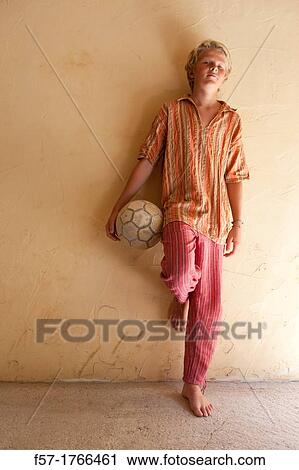 Teenage boy holding a football View Large Photo Image Stock Image - Teenage boy holding a football. Fotosearch