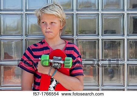 Teenage boy holding a long board View Large Photo Image Picture - Teenage boy holding a long board. Fotosearch