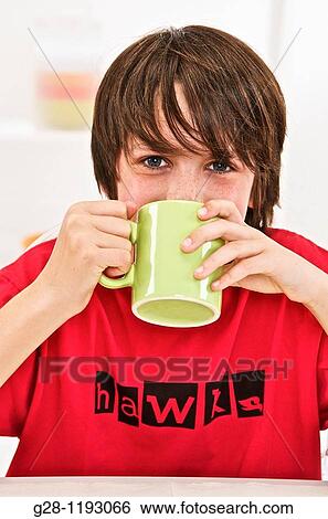 teenage boy in a red T shirt, drinking out of a green mug at home View Large Photo Image Stock Photograph - teenage boy in a red T shirt, drinking out of a green mug at home. Fotosearch