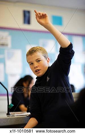 Stock Image - Teenage boy in class, secondary school, UK. Fotosearch