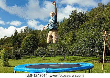 Teenage Boy Jumping on Trampoline View Large Photo Image Picture - Teenage Boy Jumping on Trampoline. Fotosearch