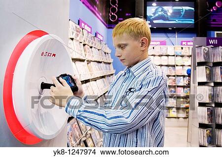 Teenage Boy Playing Computer Game in Store View Large Photo Image Picture - Teenage Boy Playing Computer Game in Store. Fotosearch