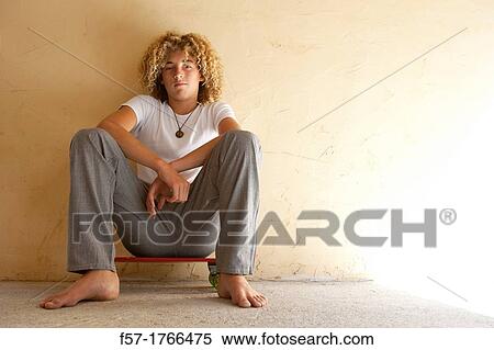 Teenage boy sitting on his longboard View Large Photo Image Stock Photography - Teenage boy sitting on his longboard. Fotosearch