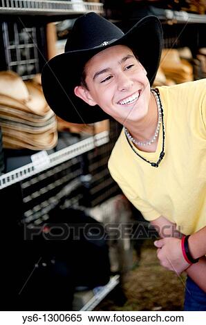 Stock Photography - Teenage Boy Smiling Wearing a Cowboy Hat at Dixie Classic Fair, Winston Salem, NC. Fotosearch