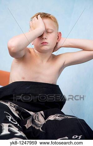 Stock Photo - Teenage Boy Stretching After Sleeping. Fotosearch