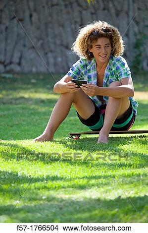 Teenage boy using his smart phone View Large Photo Image Picture - Teenage boy using his smart phone. Fotosearch