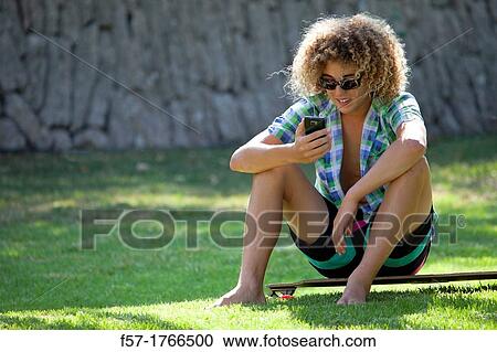 Teenage boy using his smart phone View Large Photo Image Stock Image - Teenage boy using his smart phone. Fotosearch