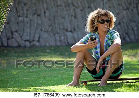 Teenage boy using his smart phone View Large Photo Image Stock Photo - Teenage boy using his smart phone. Fotosearch