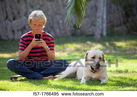 Teenage boy using his smart phone View Large Photo Image Stock Photography - Teenage boy using his smart phone. Fotosearch