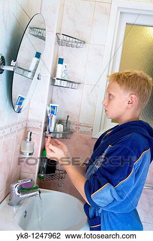 Teenage Boy Washing in Bathroom and Looking Mirror View Large Photo Image Stock Image - Teenage Boy Washing in Bathroom and Looking Mirror. Fotosearch