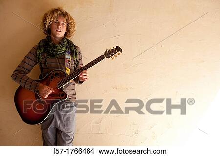 Teenage boy with his guitar View Large Photo Image Picture - Teenage boy with his guitar. Fotosearch
