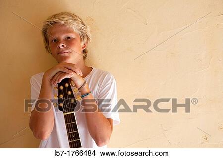 Picture - Teenage boy with his guitar. Fotosearch