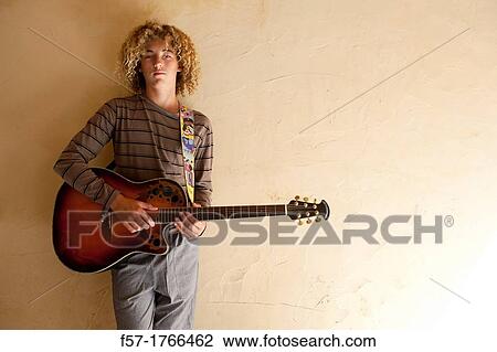 Teenage boy with his guitar View Large Photo Image Stock Image - Teenage boy with his guitar. Fotosearch
