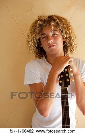 Teenage boy with his guitar View Large Photo Image Stock Image - Teenage boy with his guitar. Fotosearch