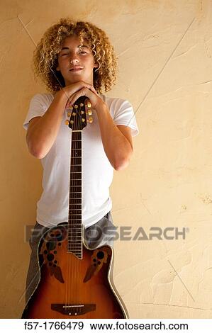 Teenage boy with his guitar View Large Photo Image Stock Photo - Teenage boy with his guitar. Fotosearch