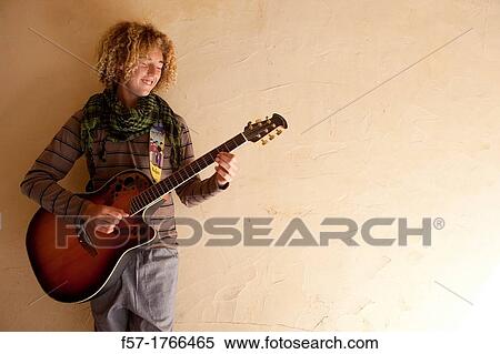 Stock Photography - Teenage boy with his guitar. Fotosearch
