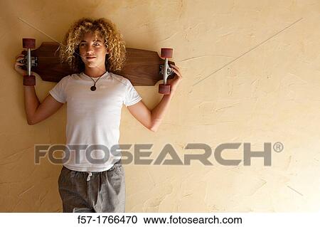 Teenage boy with his longboard View Large Photo Image Stock Image - Teenage boy with his longboard. Fotosearch