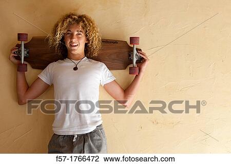 Teenage boy with his longboard View Large Photo Image Stock Image - Teenage boy with his longboard. Fotosearch