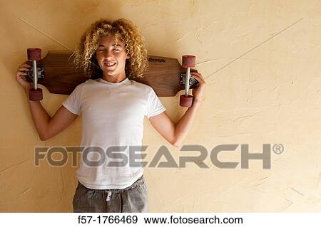 Teenage boy with his longboard View Large Photo Image Stock Photo - Teenage boy with his longboard. Fotosearch
