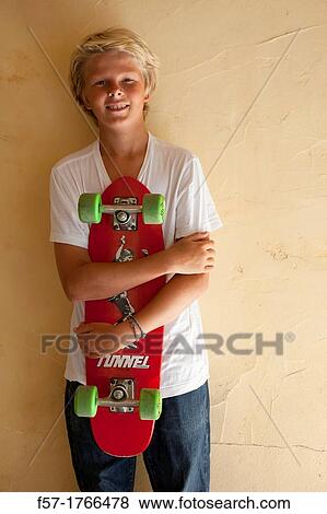 Stock Photo - Teenage boy with his longboard. Fotosearch