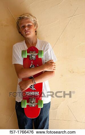 Teenage boy with his longboard View Large Photo Image Stock Photograph - Teenage boy with his longboard. Fotosearch