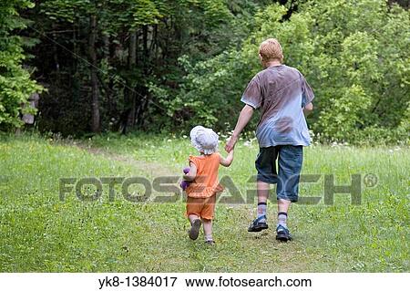 Teenage Boy with Kid Girl Hand in Hand Walking Away in Forest View Large Photo Image Stock Photo - Teenage Boy with Kid Girl Hand in Hand Walking Away in Forest. Fotosearch