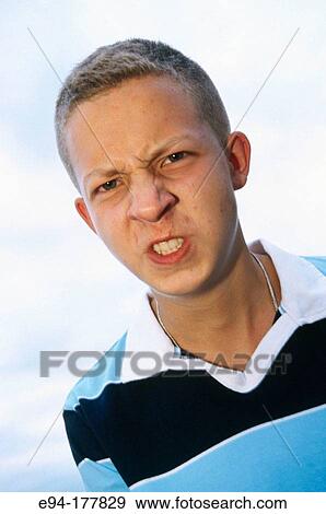 Teenage boy with short blond hair making an angry face View Large Photo Image Stock Photo - Teenage boy with short blond hair making an angry face. Fotosearch