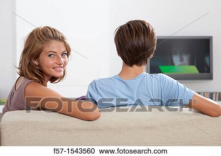 Teenage couple watching TV View Large Photo Image Stock Image - Teenage couple watching TV. Fotosearch