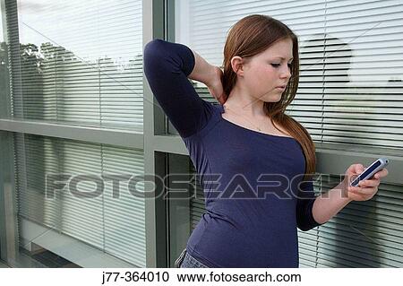 Teenage female with cell phone View Large Photo Image Stock Image - Teenage female with cell phone. Fotosearch
