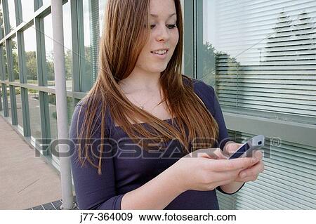 Teenage female with cell phone View Large Photo Image Stock Photo - Teenage female with cell phone. Fotosearch