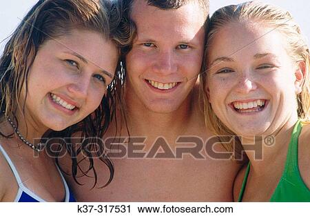 Teenage friends on beach View Large Photo Image Stock Image - Teenage friends on beach. Fotosearch