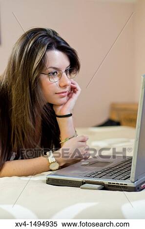 Teenage girl chatting with notebook in her home View Large Photo Image Stock Photography - Teenage girl chatting with notebook in her home. Fotosearch