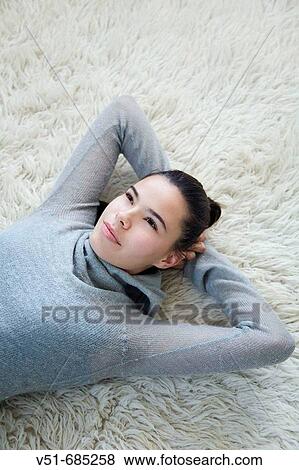 Stock Photo - Teenage girl daydreaming at home. Fotosearch