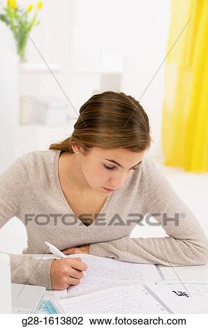 teenage girl doing her homework at home View Large Photo Image Stock Image - teenage girl doing her homework at home. Fotosearch