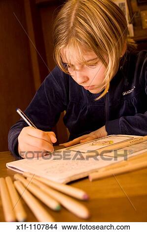 Picture - teenage girl doing her homework. Fotosearch