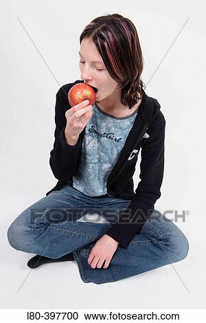 Teenage girl eating an apple. View Large Photo Image Stock Image - Teenage girl eating an apple.. Fotosearch