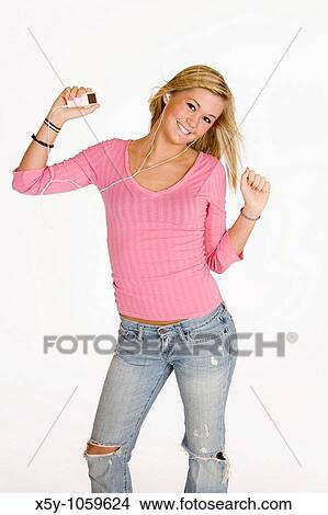 Teenage girl listening to music on an MP3 player View Large Photo Image Picture - Teenage girl listening to music on an MP3 player. Fotosearch