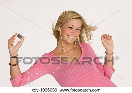 Teenage girl listening to music on an MP3 player View Large Photo Image Stock Image - Teenage girl listening to music on an MP3 player. Fotosearch