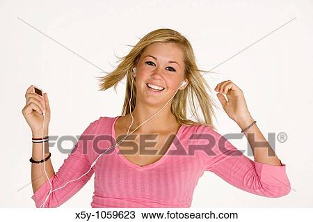Teenage girl listening to music on an MP3 player View Large Photo Image Stock Image - Teenage girl listening to music on an MP3 player. Fotosearch