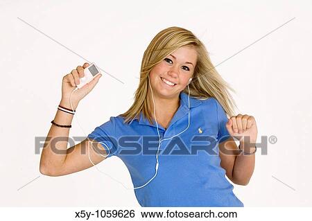 Teenage girl listening to music on an MP3 player View Large Photo Image Stock Photograph - Teenage girl listening to music on an MP3 player. Fotosearch