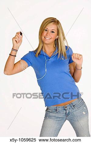 Stock Photography - Teenage girl listening to music on an MP3 player. Fotosearch