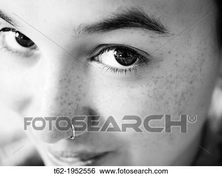 Teenage girl looking at camera smiling with big eyes. View Large Photo Image Stock Photograph - Teenage girl looking at camera smiling with big eyes.. Fotosearch