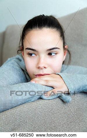 Teenage girl lying on the couch daydreaming View Large Photo Image Stock Image - Teenage girl lying on the couch daydreaming. Fotosearch