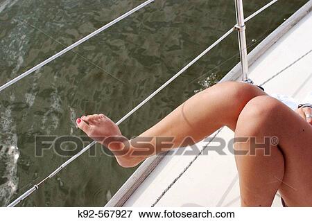 Teenage girl on a sailboat View Large Photo Image Stock Photo - Teenage girl on a sailboat. Fotosearch