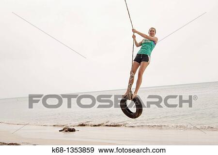 Stock Photo - teenage girl on holiday at the beach in the tropics. Fotosearch