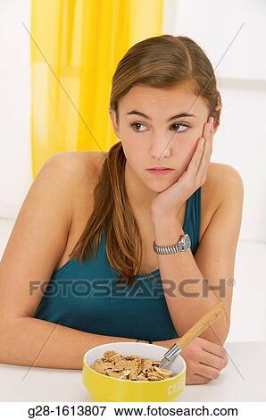 Teenage girl refusing to eat her cereals suffering from anorexia View Large Photo Image Stock Photo - Teenage girl refusing to eat her cereals suffering from anorexia. Fotosearch