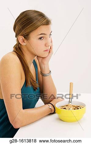 Teenage girl refusing to eat her cereals suffering from anorexia View Large Photo Image Stock Photo - Teenage girl refusing to eat her cereals suffering from anorexia. Fotosearch