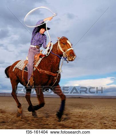 Teenage girl rodeo champion roping on horseback. Colorado. USA View Large Photo Image Picture - Teenage girl rodeo champion roping on horseback. Colorado. USA. Fotosearch