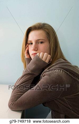 Teenage girl sitting at a desk. View Large Photo Image Stock Photo - Teenage girl sitting at a desk.. Fotosearch