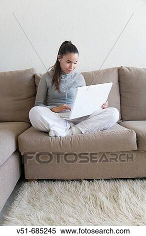 Teenage girl surfing the net in the couch View Large Photo Image Stock Photography - Teenage girl surfing the net in the couch. Fotosearch